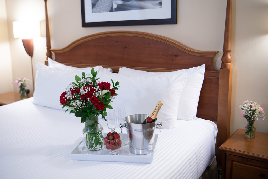 Roses And Champagne On Bed