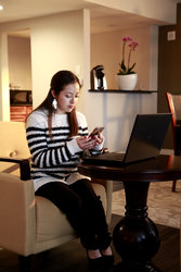 Girl on Phone and Laptop in Parlor