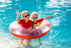 Kids In Water Tube In Pool