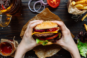 Hands Holding Take Out Burgers