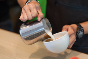 Young Man Making Latte