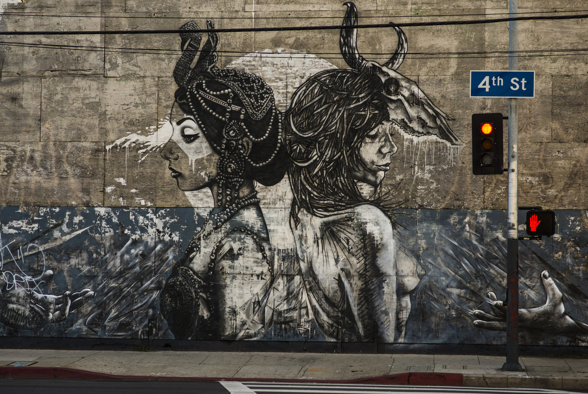 A large mural on a wall depicting a mythical creature and a woman.