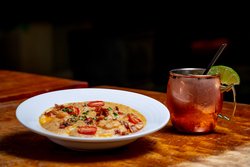 Shrimp And Grits With Tomatoes And Bacon With Cocktail